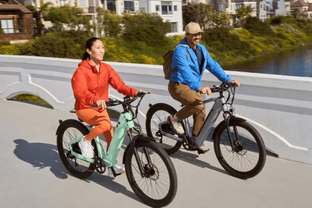 A couple riding on their Velotric e-bikes