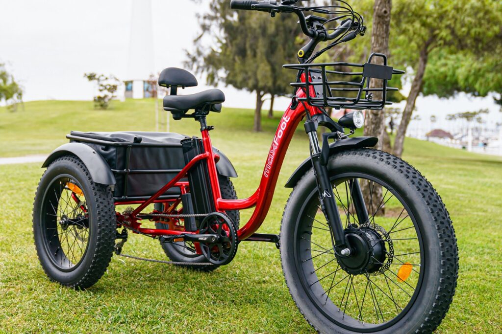 A Maxfoot electric tricycle in candy red