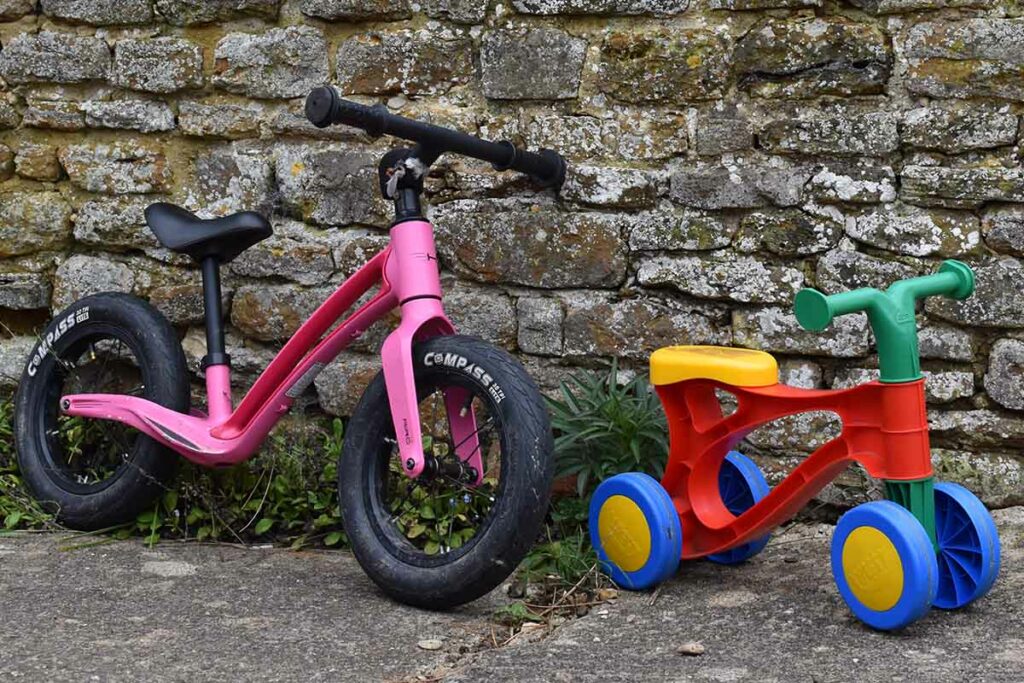 A Pink bicycle and a colourful push bike for kids learning to ride