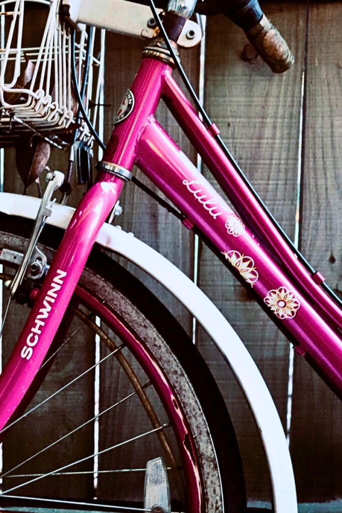 Name decal on pink bicycle
