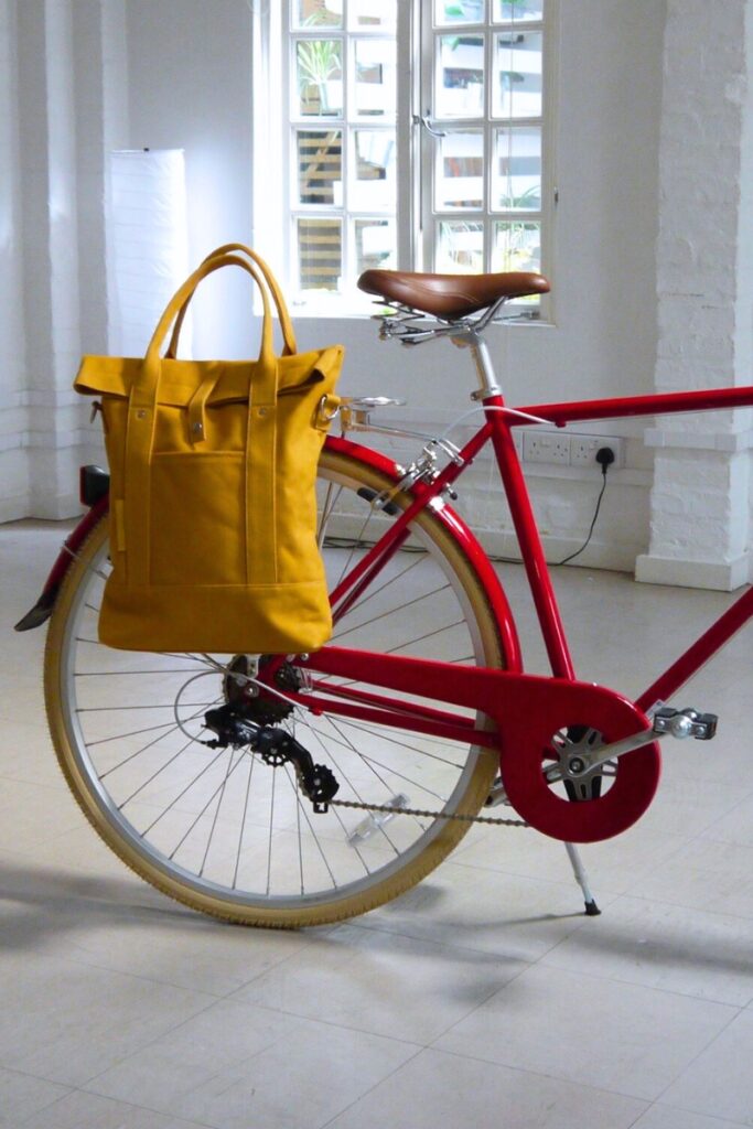 A red bicycle with a yellow pannier bag