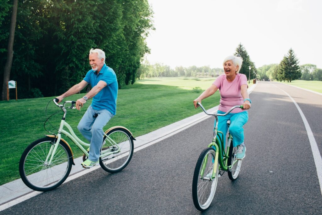 older couple cycling down the street