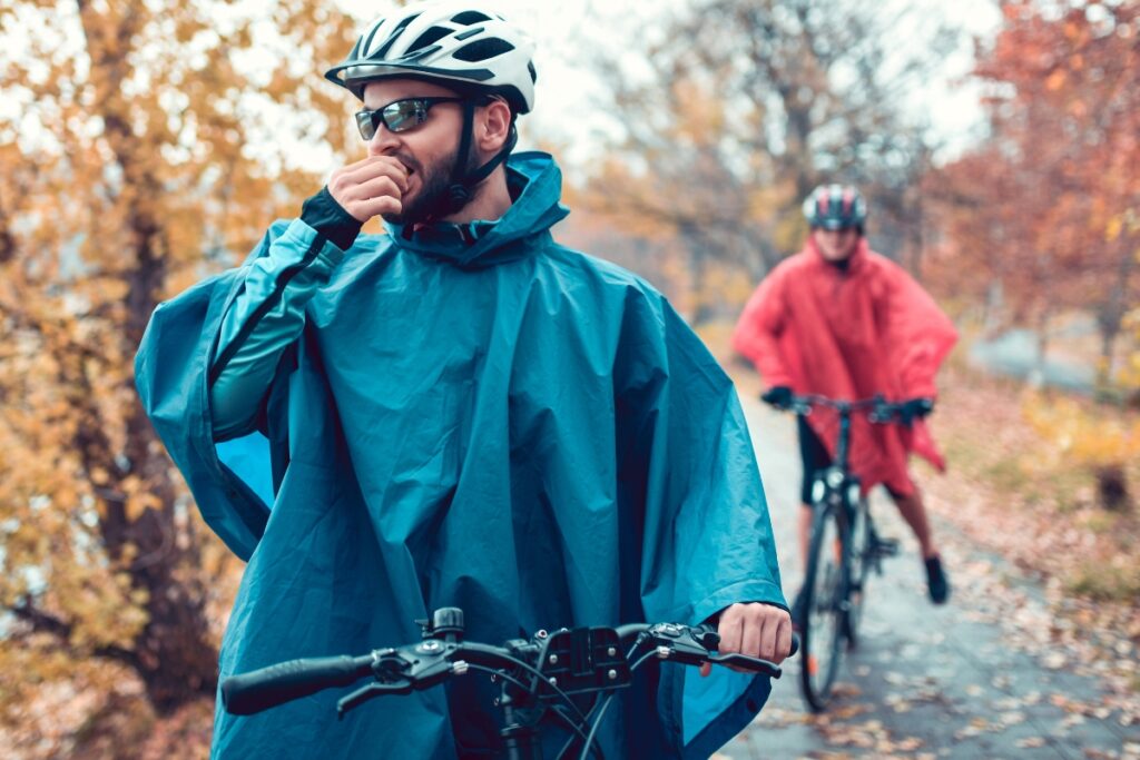 Man cycling in the rain with sunglasses on