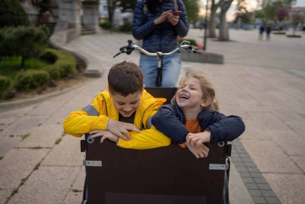 children being transported in a cargo bike