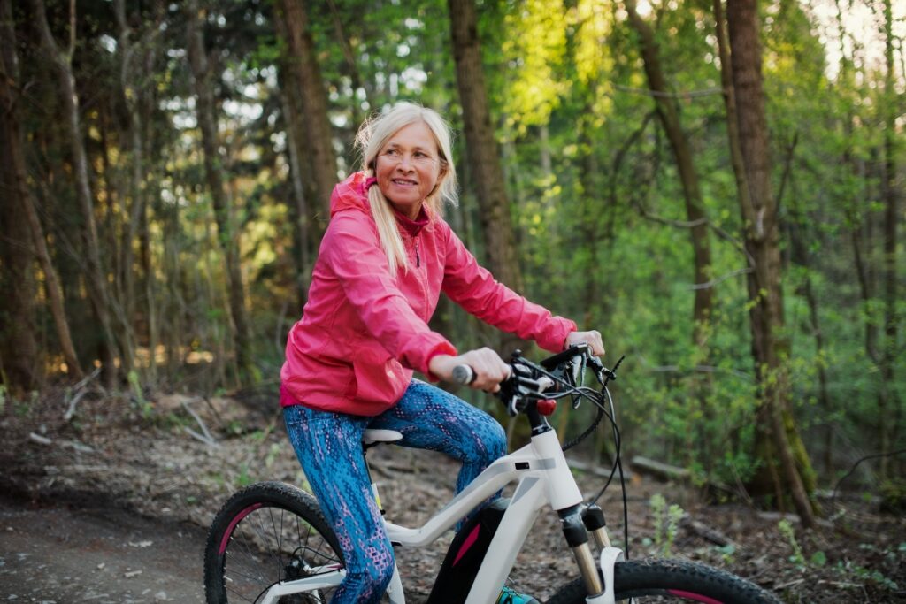 Woman riding e-bike in woods