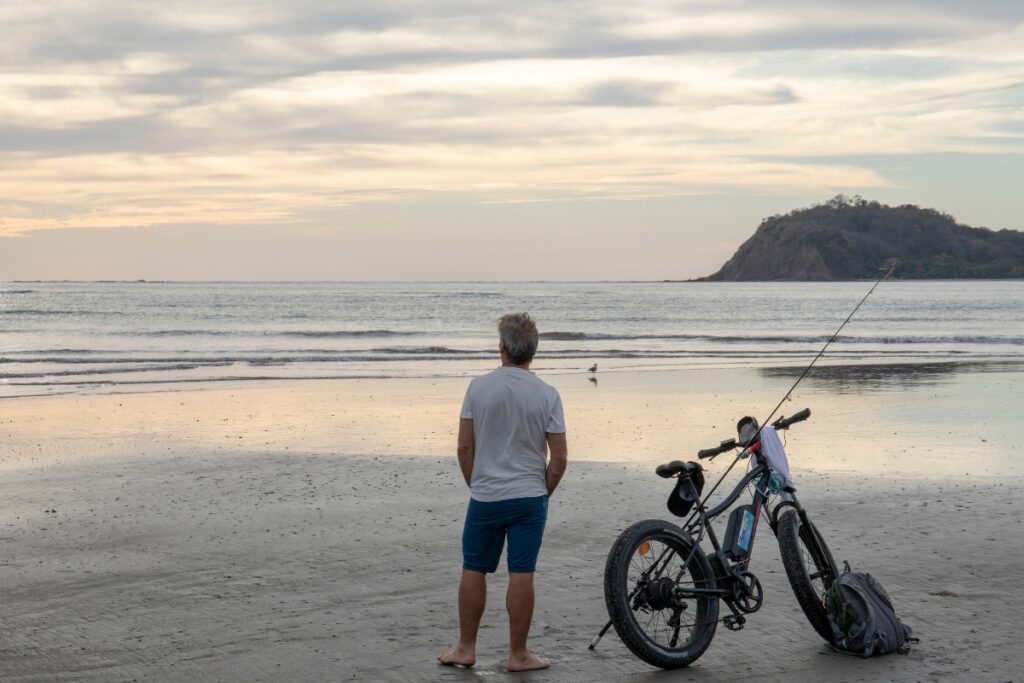 man with e-bike on the beach