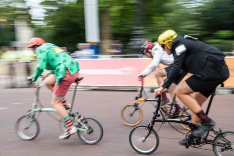Cyclists in suits taking part in the Brompton world championship